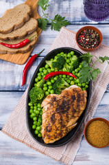 Fried chicken breast with green vegetables