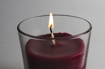 burning candle in a glass isolated