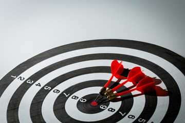 dart arrow hitting in the target center of dartboard. concept of the success