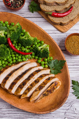 Fried chicken breast with green vegetables