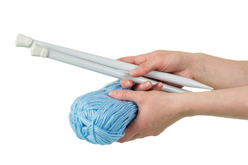 Skein of blue yarn and thick spokes in woman's hands isolated on white