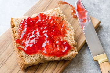 Red Plum Marmalade Jam with Bread and in glass Bowl.
