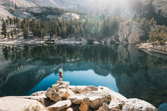 young man in  Yosemite, USA: Mountain landscape with mirror lake surrounded by high peaks