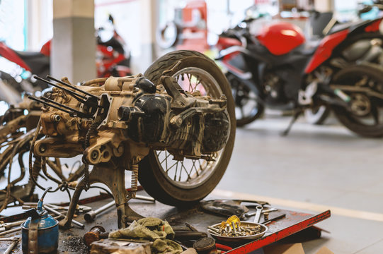 motorcycle in repair station with soft-focus and over light in the background