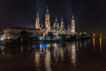 Naklejka premium Pilar Zaragoza mighty Ebro river, Basilica Cathedral night illumination water reflection Aragon Spain, gigapan