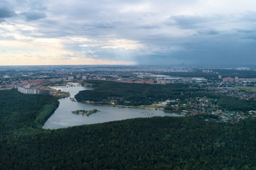 Aerial view of wheat fields, meadow, forest and village in rural Russia.
