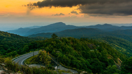 mountain view and sunset the forest with road on the morning at Doi Inthanon National Park, Chiang Mai, Thailand.