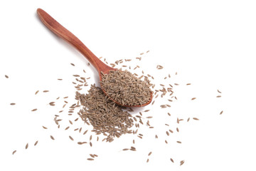 dry zira seeds spice in the spoon isolated on the white