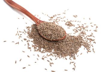 dry zira seeds spice in the spoon isolated on the white