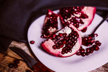 Ripe red pomegranate on the plate