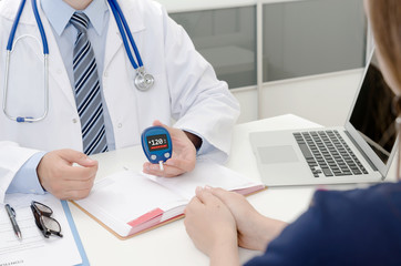 Doctor and patient diabetes consultation in office or clinic.
