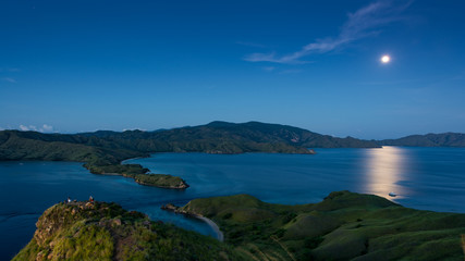 A Full Moon in Early Morming Before Sunrise At Gili Lawa with Clear Sky and Blue Sea. Komodo National Park, Labuan Bajo, Flores, Indonesia © Pnnchen