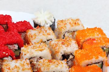 Sushi on a light background, close-up. With caviar of flying fish. Fresh colored sushi.