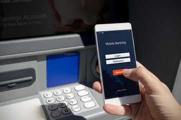 Person holding a phone with a login screen for mobile banking