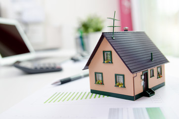 House model on desk, mortgage or house building concept