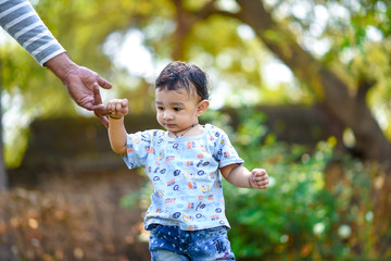 cute indian baby boy playing at garden