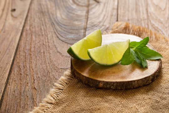 Fresh lime on the brown wooden table