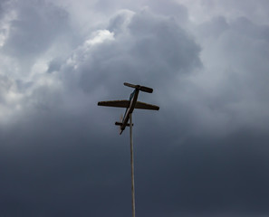 wind airplane on the background of storm gray clouds