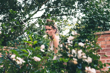 beautiful young woman in her green natural garden