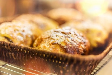 French almond chocolate croissant in bamboo woven basket, selective focus and lens flare