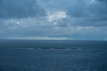 little tower on a smal island in the ocean in norway