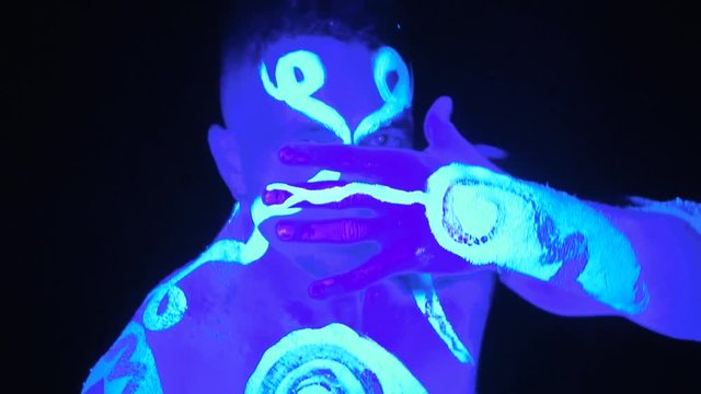 Man painted in ultraviolet paint