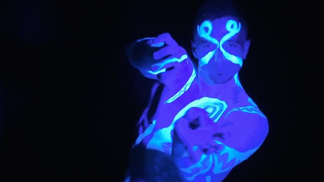 Man painted in ultraviolet paint