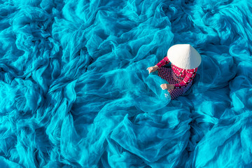 Fototapeta premium Vietnamese woman repair fishing net