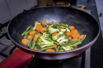Cooking vegetables in pan closeup