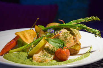 Grilled salmon with potatoes. Decorated chili and asparagus