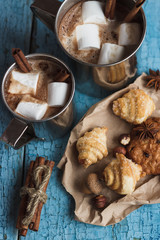 Metal mugs with cacao and marshmallows