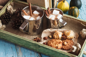 Metal mugs with cacao and marshmallows