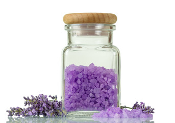 Glass jar with sea salt, near lavender sprigs isolated on white