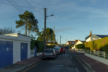 Country houses with fences and streets in the region of Normandy, France. Beautiful countryside, lifestyle and typical french architecture, european country landscapes