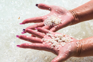 Hand finger in sand at the sea