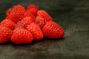 Raspberries on dark background, dark food photography