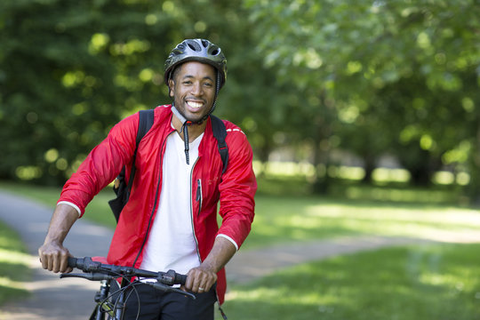 Young Man Cycling In The Park