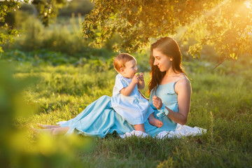 Fototapeta premium mother with little daughter playing on green grass