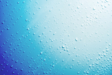 Naklejka na ściany i meble Water droplets on blue background.