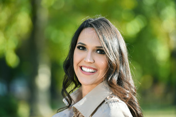 young fashion woman portrait in a park in autumn