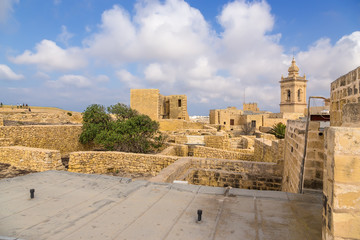 Victoria, the island of Gozo, Malta. The bell tower of the cathedral and the city buildings inside the Citadel