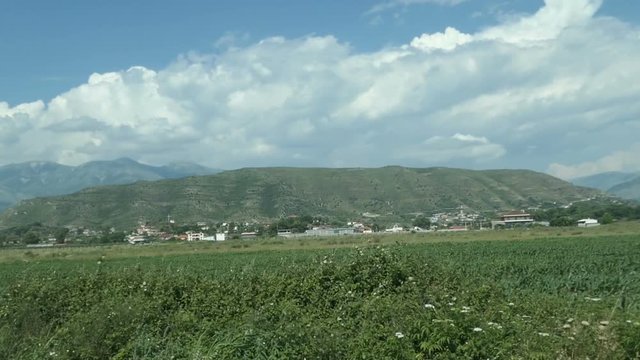 driving along a field next to Albanian city Phoinike.