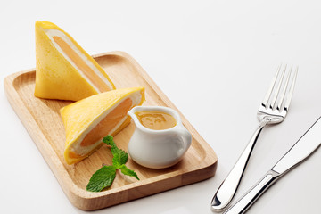 close up view of nice yummy crepes with jam on white table