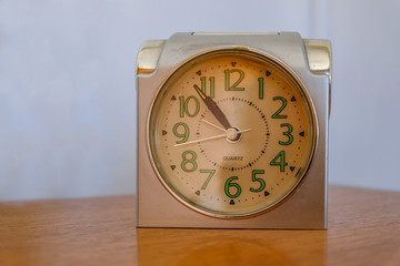 Old alarm clock at five to eleven.