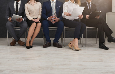 Group of business people sitting with gadgets