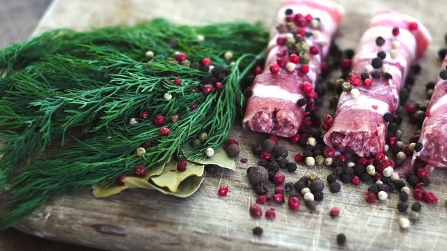 On a wooden board lined with chyvanchichi, green fresh dill, laurel leaves, a sprig is scattered from the spoon. Cooking. Posting, Macro, clouse-up