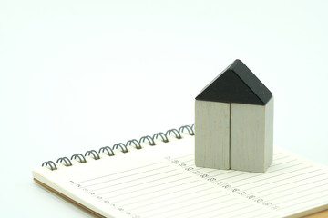 A model house model is placed on a Calendar. as background property real estate concept with copy space for your text or  design.