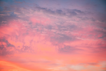 Details of clouds at sunset with dark orange, pink, and blueish purple tones
