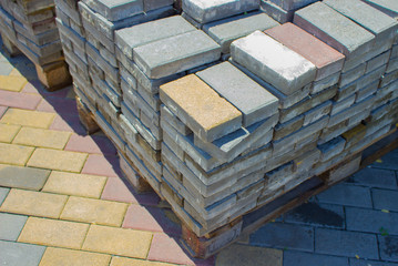 A multicolored paving slab is stacked on a ready-made path.