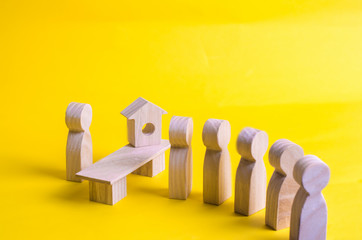 The seller is behind the counter and serves customers. A queue of customers is standing in line and waiting for their turn to service. Sale, shop. Real estate agent, buying a house.